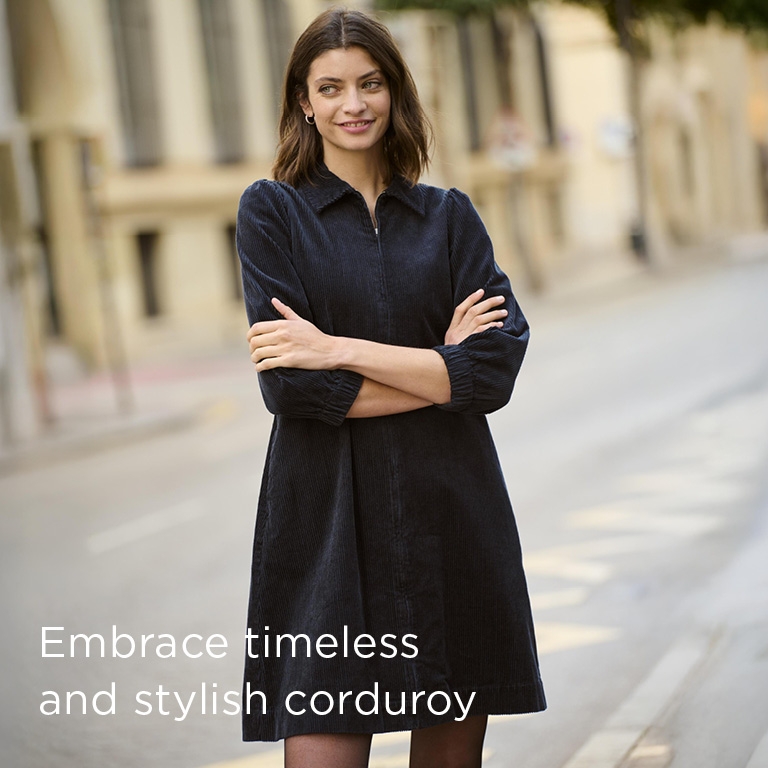 Woman strolling the streets in a blue corduroy dress